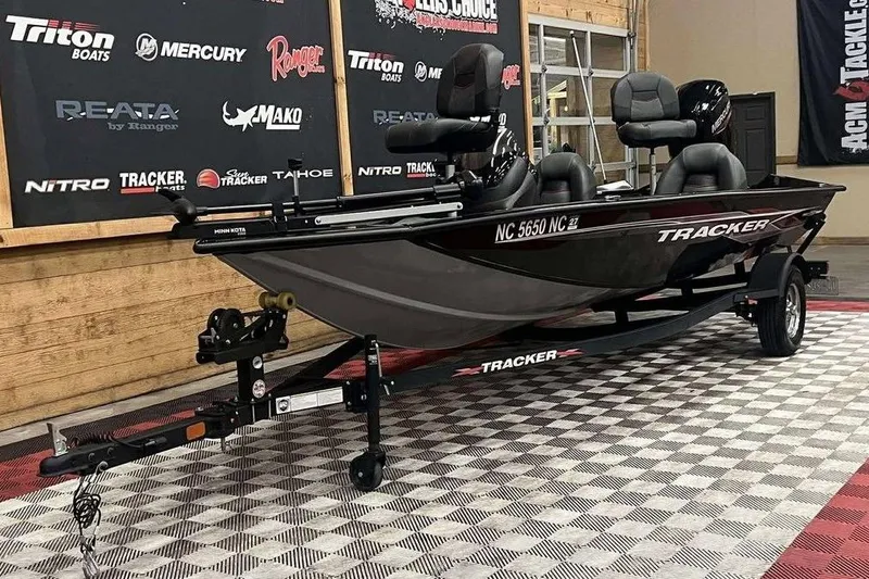 Slide: The Image of 2024 Tracker Pro Team 175 TXW boat on display in showroom with branded backdrop. - 4