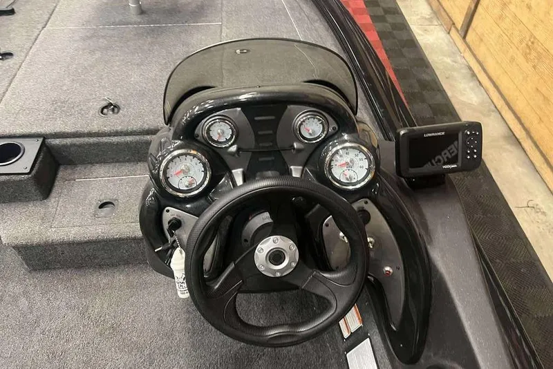 Slide: The Image of 2024 Tracker Pro Team 175 TXW boat dashboard with gauges and steering wheel. - 7