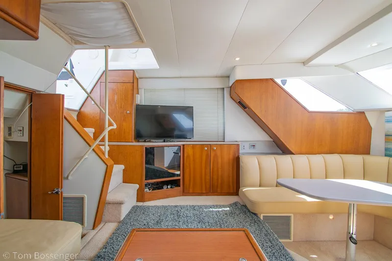Slide: The Image of Luxurious interior of a 1996 Silverton 372 Motor Yacht with modern furnishings and entertainment setup. - 10