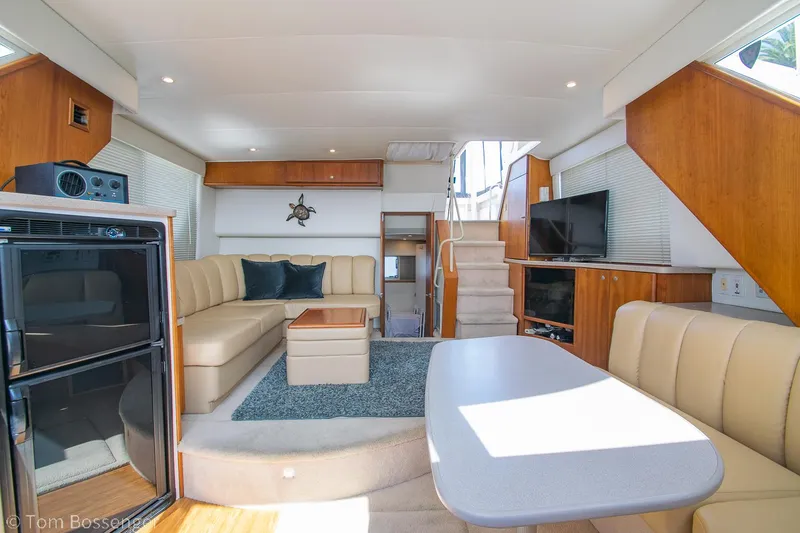 Slide: The Image of Interior of a 1996 Silverton 372 Motor Yacht with modern furnishings and ample seating. - 16
