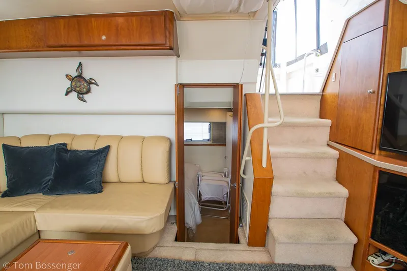 Slide: The Image of Interior of 1996 Silverton 372 Motor Yacht with beige seating and wooden accents. - 18