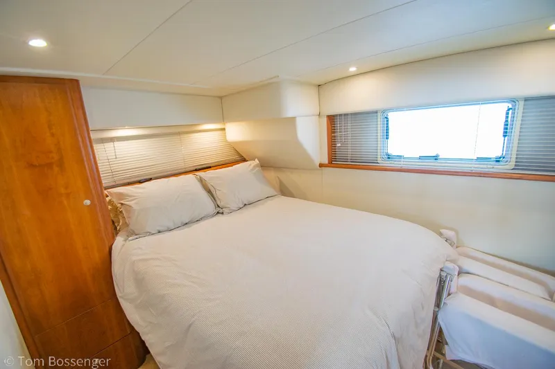 Slide: The Image of Cozy bedroom in 1996 Silverton 372 Motor Yacht with window and wooden accents. - 19