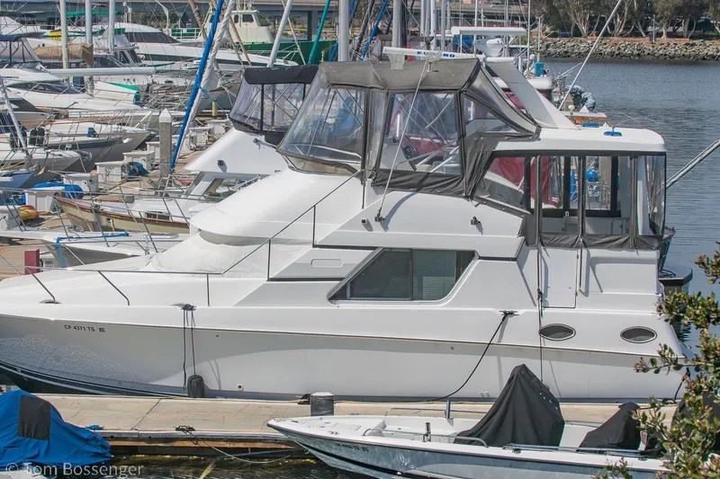 Slide: The Image of 1996 Silverton 372 Motor Yacht docked at a marina, surrounded by other boats. - 2
