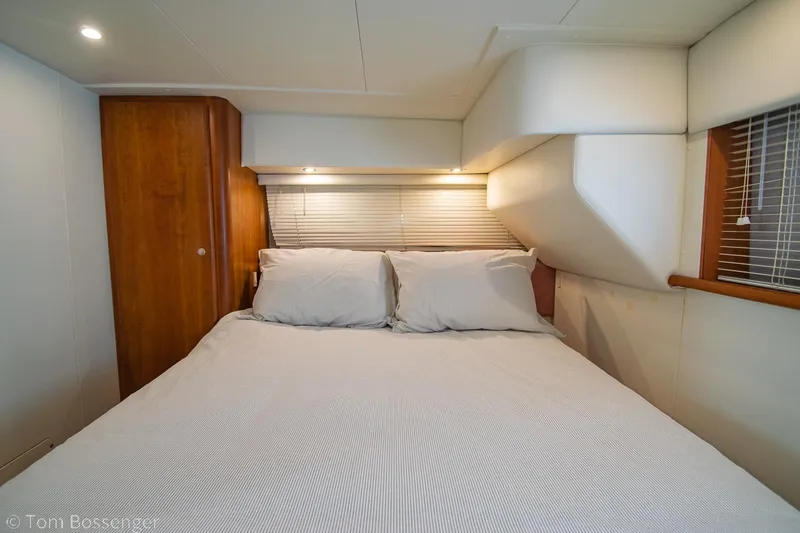 Slide: The Image of 1996 Silverton 372 Motor Yacht bedroom with cozy bed and wooden accents. - 20
