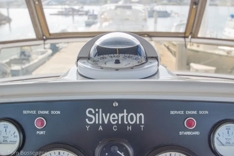 Slide: The Image of 1996 Silverton 372 Motor Yacht dashboard with compass and engine gauges. - 39