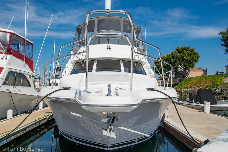 Slide: The Image of 1996 Silverton 372 Motor Yacht docked at marina under clear blue sky. - 4