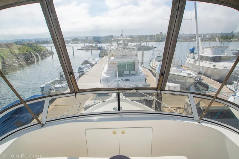 Slide: The Image of 1996 Silverton 372 Motor Yacht docked at a marina, view from the helm. - 45