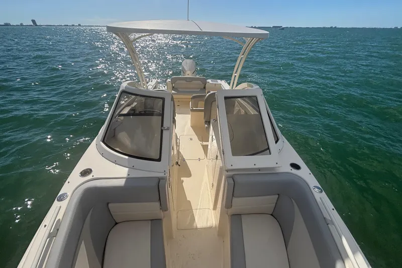 Slide: The Image of 2024 Scout 240 Dorado boat on open water, featuring spacious seating and sleek design. - 15