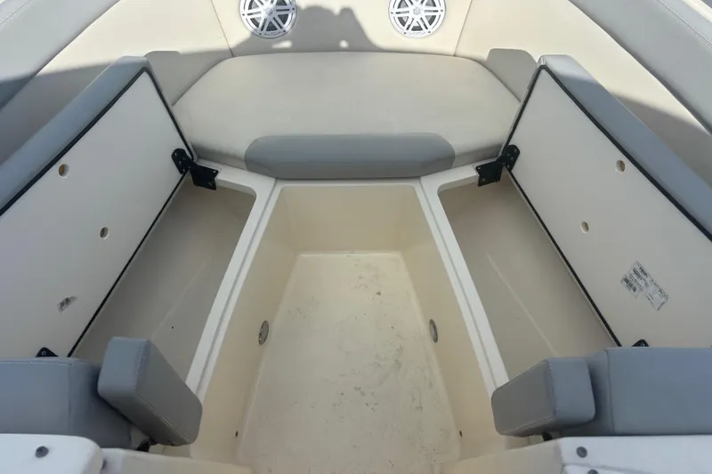 Slide: The Image of 2024 Scout 240 Dorado boat interior with open storage compartments and seating. - 17
