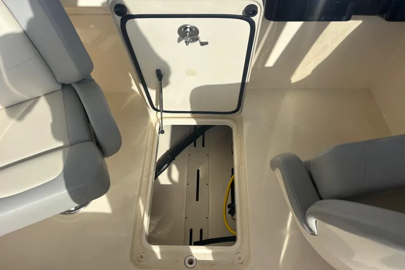 Slide: The Image of 2024 Scout 240 Dorado boat interior with open storage compartment and seating. - 21