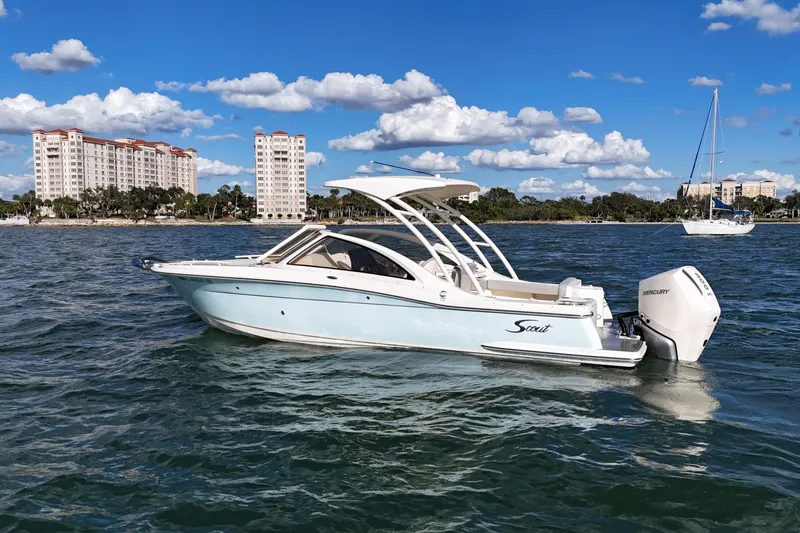 Slide: The Image of 2024 Scout 240 Dorado boat on water with cityscape background. - 3