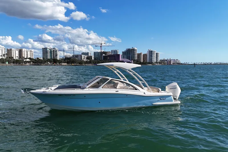 Slide: The Image of 2024 Scout 240 Dorado boat on water with city skyline in background. - 8