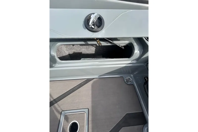 Slide: The Image of 2026 Lund 185 Impact GL boat interior storage compartment and flooring detail. - 16