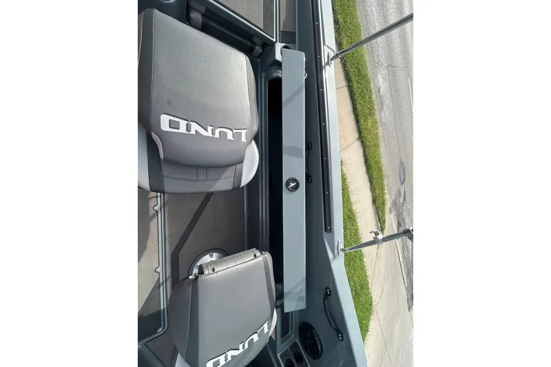 Slide: The Image of 2026 Lund 185 Impact GL boat interior with branded seats and sleek design. - 17