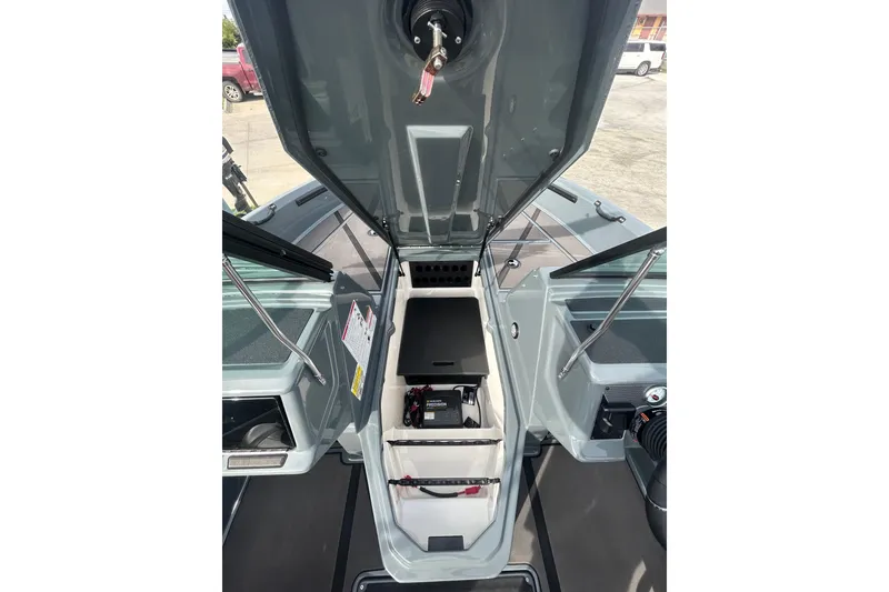 Slide: The Image of 2026 Lund 185 Impact GL boat interior with open storage compartments and visible equipment. - 21