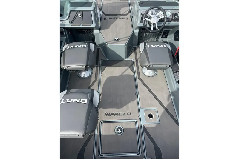 Slide: The Image of 2026 Lund 185 Impact GL boat interior with branded seats and steering console. - 24