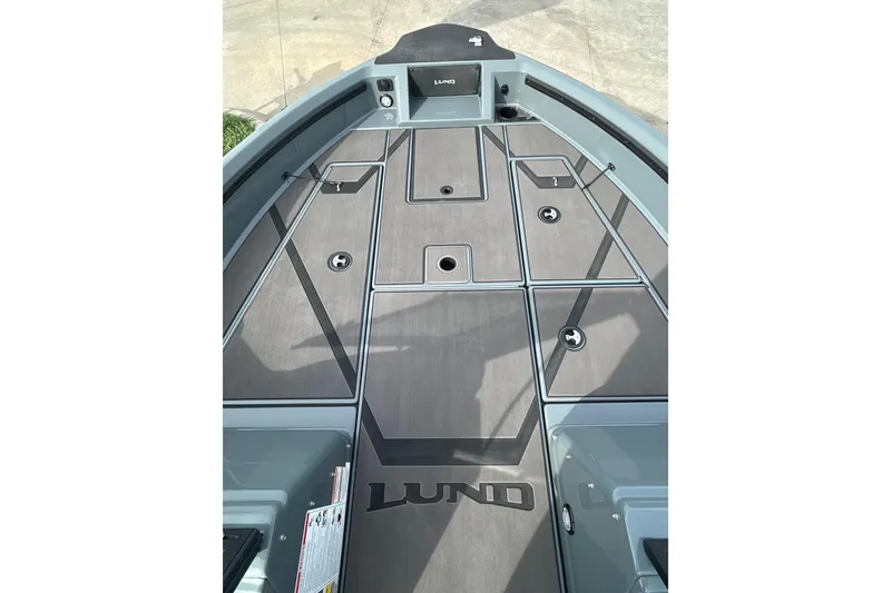 Slide: The Image of 2026 Lund 185 Impact GL boat deck with storage compartments and sleek design. - 25