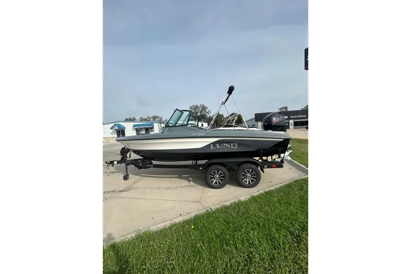 Slide: The Image of 2026 Lund 185 Impact GL boat on trailer, parked outdoors. - 3