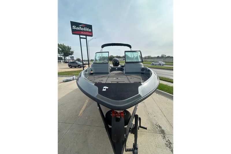 Slide: The Image of 2026 Lund 185 Impact GL boat on trailer near Safelite AutoGlass sign. - 5