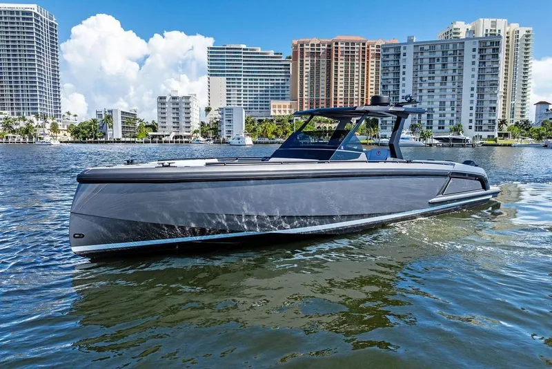 The Image of 2024 Vanquish Yachts 40 cruising in urban waterfront setting with modern buildings. - 0