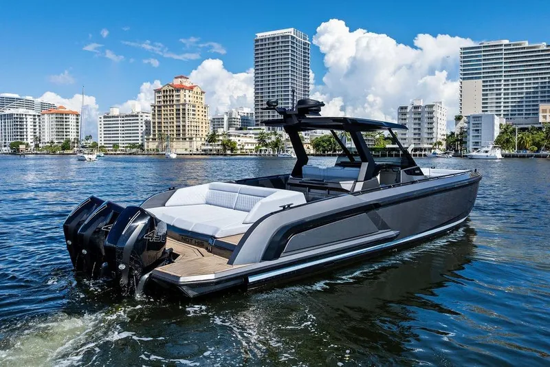 Slide: The Image of 2024 Vanquish Yachts 40 on water, city skyline background, luxury motorboat. - 12