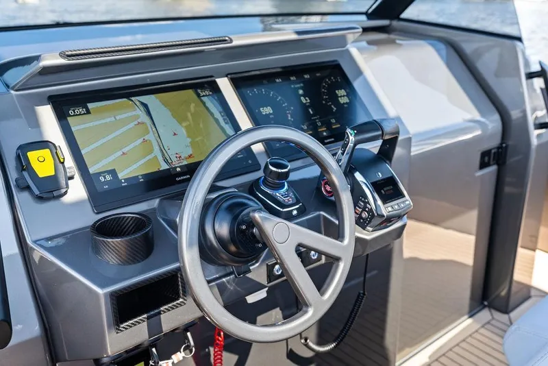 Slide: The Image of Cockpit of 2024 Vanquish Yachts 40 with advanced navigation displays and controls. - 17
