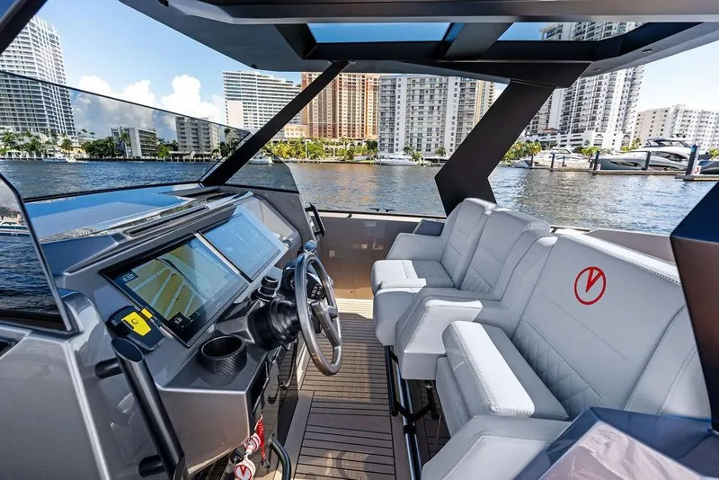 Slide: The Image of 2024 Vanquish Yachts 40 interior with modern dashboard and luxurious seating. - 18