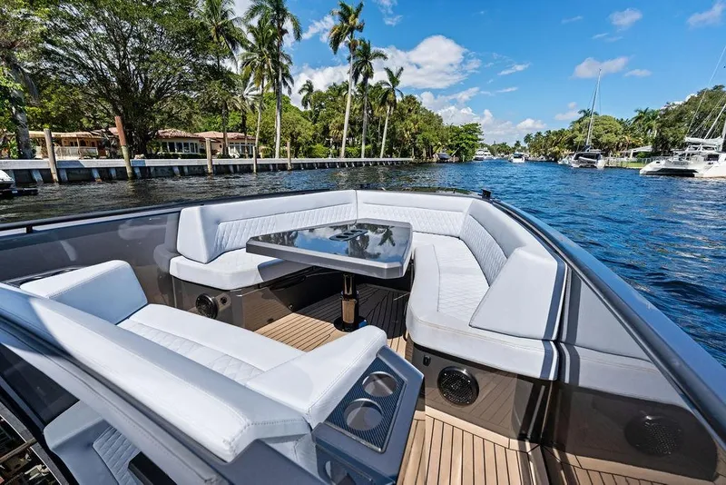 Slide: The Image of Luxurious 2024 Vanquish Yachts 40 interior with elegant seating and table, cruising on a scenic waterway. - 20