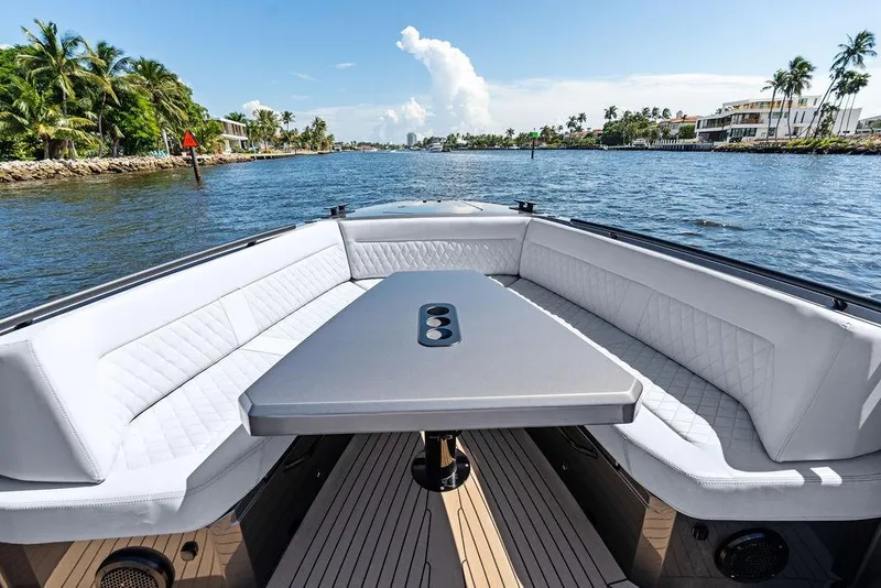 Slide: The Image of Luxurious 2024 Vanquish Yachts 40 with elegant seating and scenic waterway view. - 21