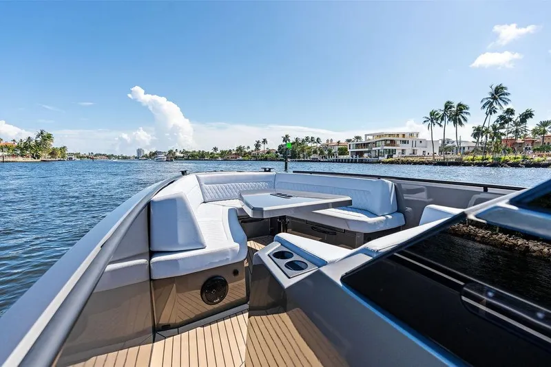 Slide: The Image of 2024 Vanquish Yachts 40 on water, featuring luxurious seating and scenic coastal view. - 24