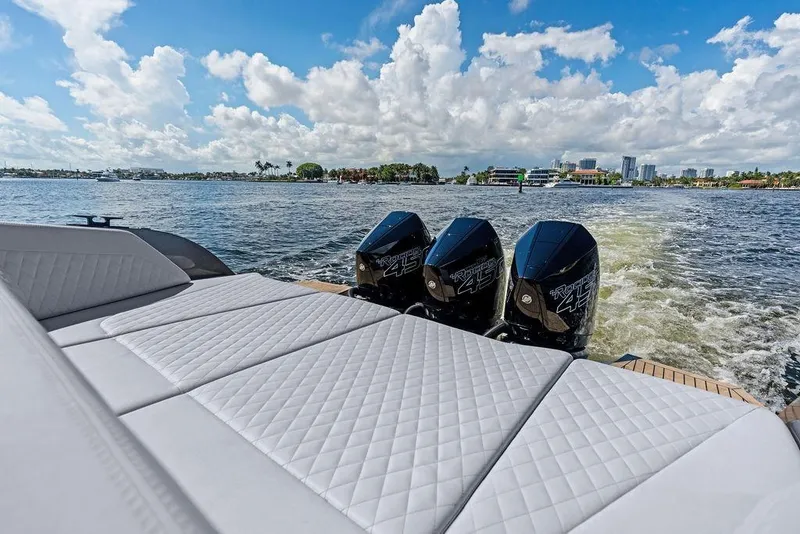 Slide: The Image of 2024 Vanquish Yachts 40 with triple outboard engines cruising on a sunny day. - 26