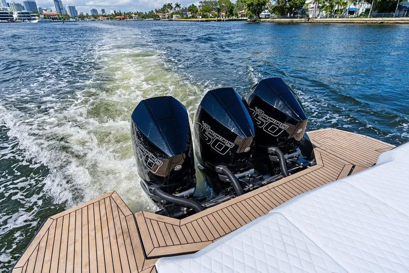 Slide: The Image of 2024 Vanquish Yachts 40 with triple outboard engines cruising on water. - 27