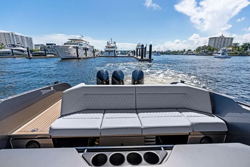 Slide: The Image of 2024 Vanquish Yachts 40, luxury yacht interior with plush seating, docked in a sunny marina. - 30