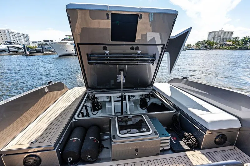 Slide: The Image of 2024 Vanquish Yachts 40 with open storage compartment, docked by the water. - 35