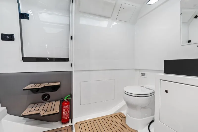 Slide: The Image of 2024 Vanquish Yachts 40 interior bathroom with modern design and wooden flooring. - 43