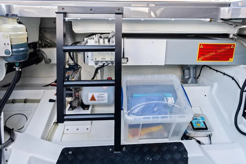 Slide: The Image of Engine compartment of 2024 Vanquish Yachts 40, featuring equipment and storage. - 47