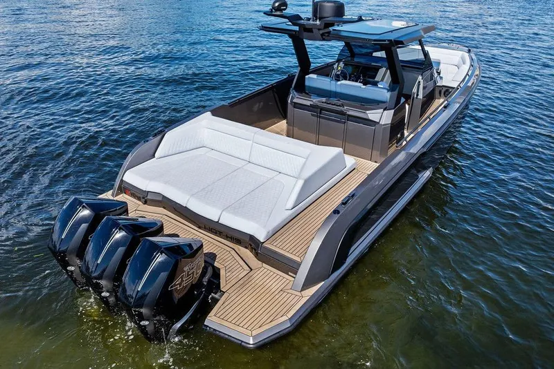 Slide: The Image of 2024 Vanquish Yachts 40 with triple engines, sleek design, and luxurious seating on water. - 6