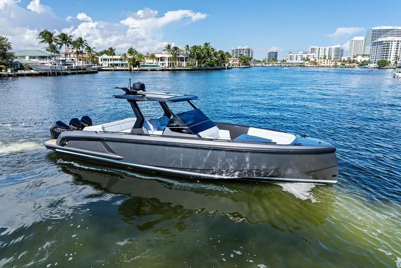 Slide: The Image of 2024 Vanquish Yachts 40 cruising on a sunny day in a coastal city. - 9