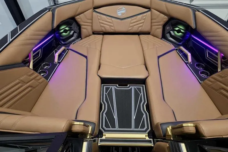 Slide: The Image of Luxurious interior of 2026 Tigé 25ZX boat with tan leather seating and ambient lighting. - 14