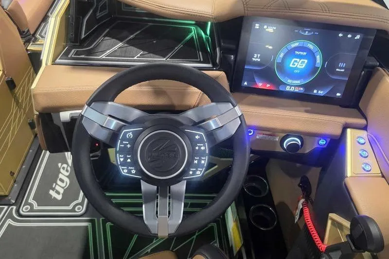 Slide: The Image of 2026 Tigé 25ZX boat dashboard with advanced steering and touchscreen controls. - 16