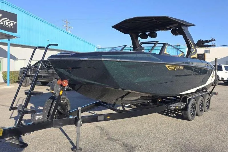 Slide: The Image of 2026 Tigé 25ZX boat on trailer at dealership, showcasing sleek design and modern features. - 3