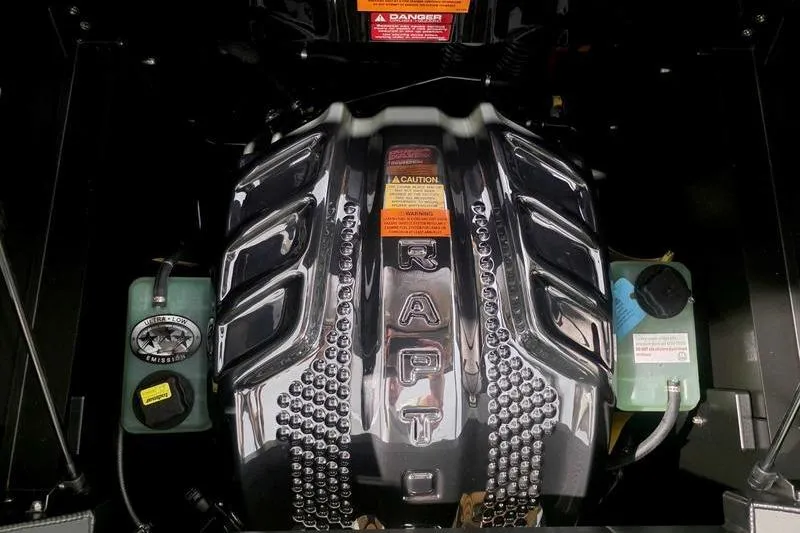Slide: The Image of Engine of 2026 Tigé 25ZX boat, featuring Raptor branding and warning labels. - 4