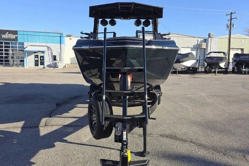 Slide: The Image of 2026 Tigé 25ZX boat on trailer in parking lot, front view. - 6