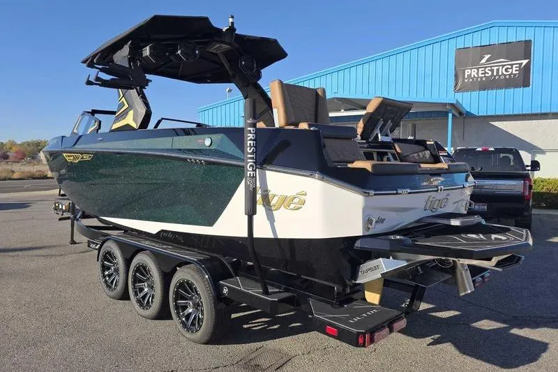 Slide: The Image of 2026 Tigé 25ZX boat on trailer at Prestige Water Sports dealership. - 8