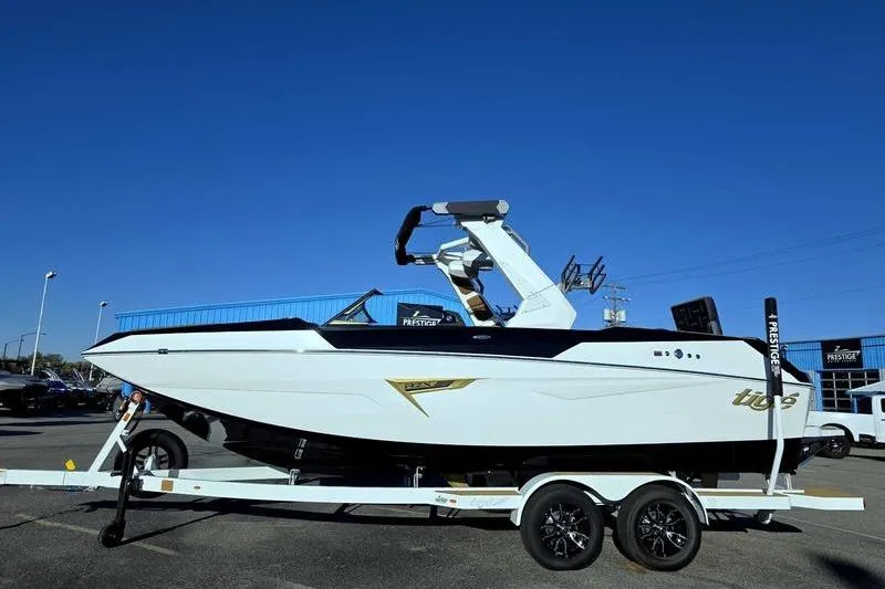 The Image of 2026 Tigé 22RZX boat on trailer under clear blue sky. - 1
