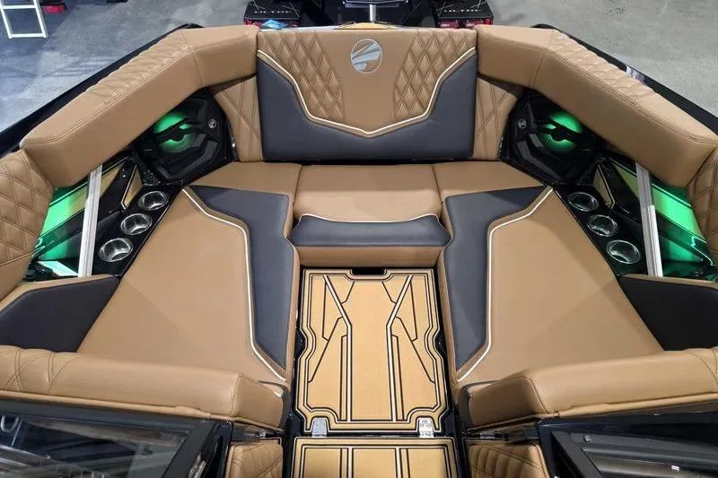 Slide: The Image of Luxurious interior of 2026 Tigé 22RZX boat with tan and black seating. - 11