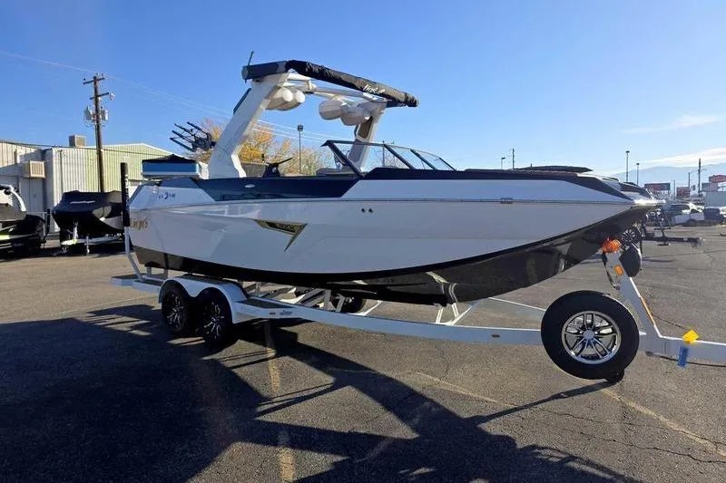 Slide: The Image of 2026 Tigé 22RZX boat on trailer in parking lot, sunny day. - 4