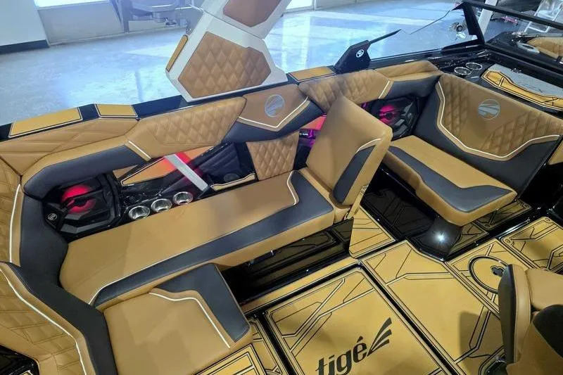 Slide: The Image of Luxurious interior of 2026 Tigé 22RZX boat with tan and black seating. - 5