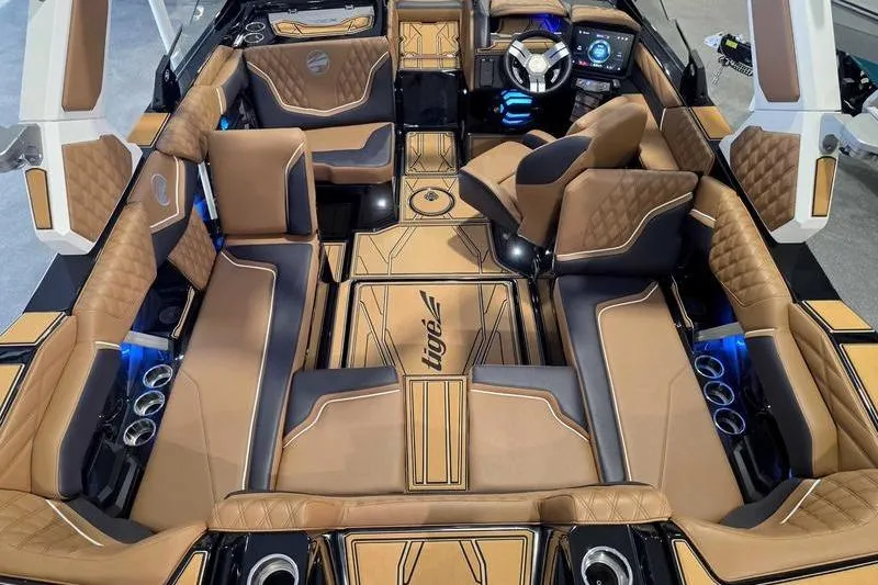 Slide: The Image of Luxurious interior of 2026 Tigé 22RZX boat with tan leather seating and modern dashboard. - 6