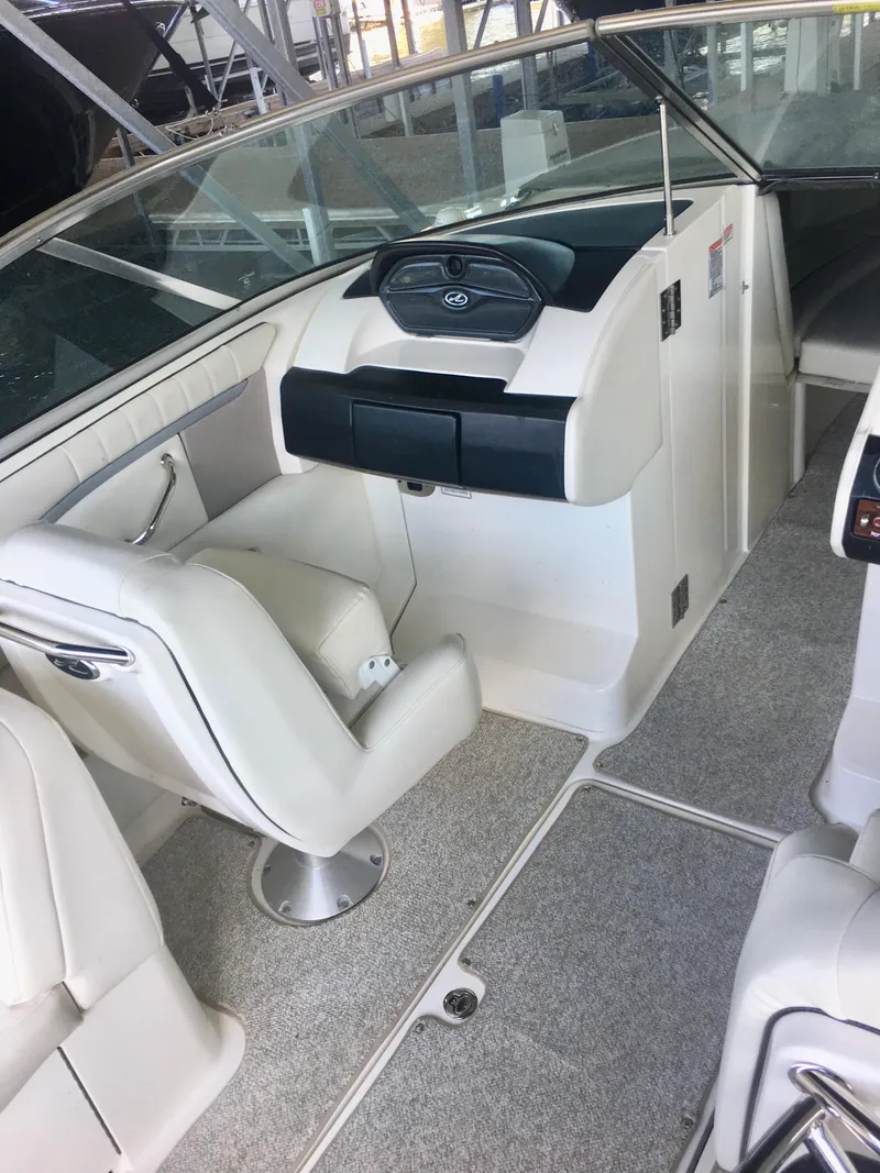 Slide: The Image of Interior of 2006 Sea Ray 270 SLX boat with beige seating and dashboard. - 5